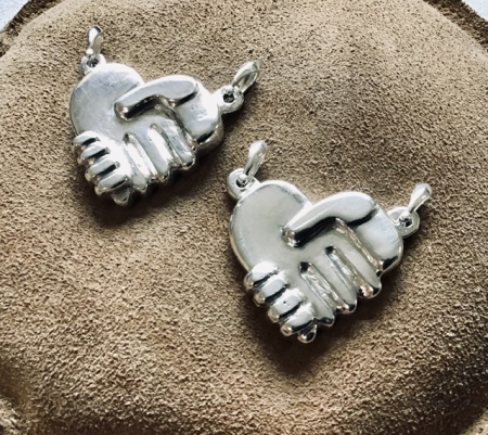 Hearts in hand pendants